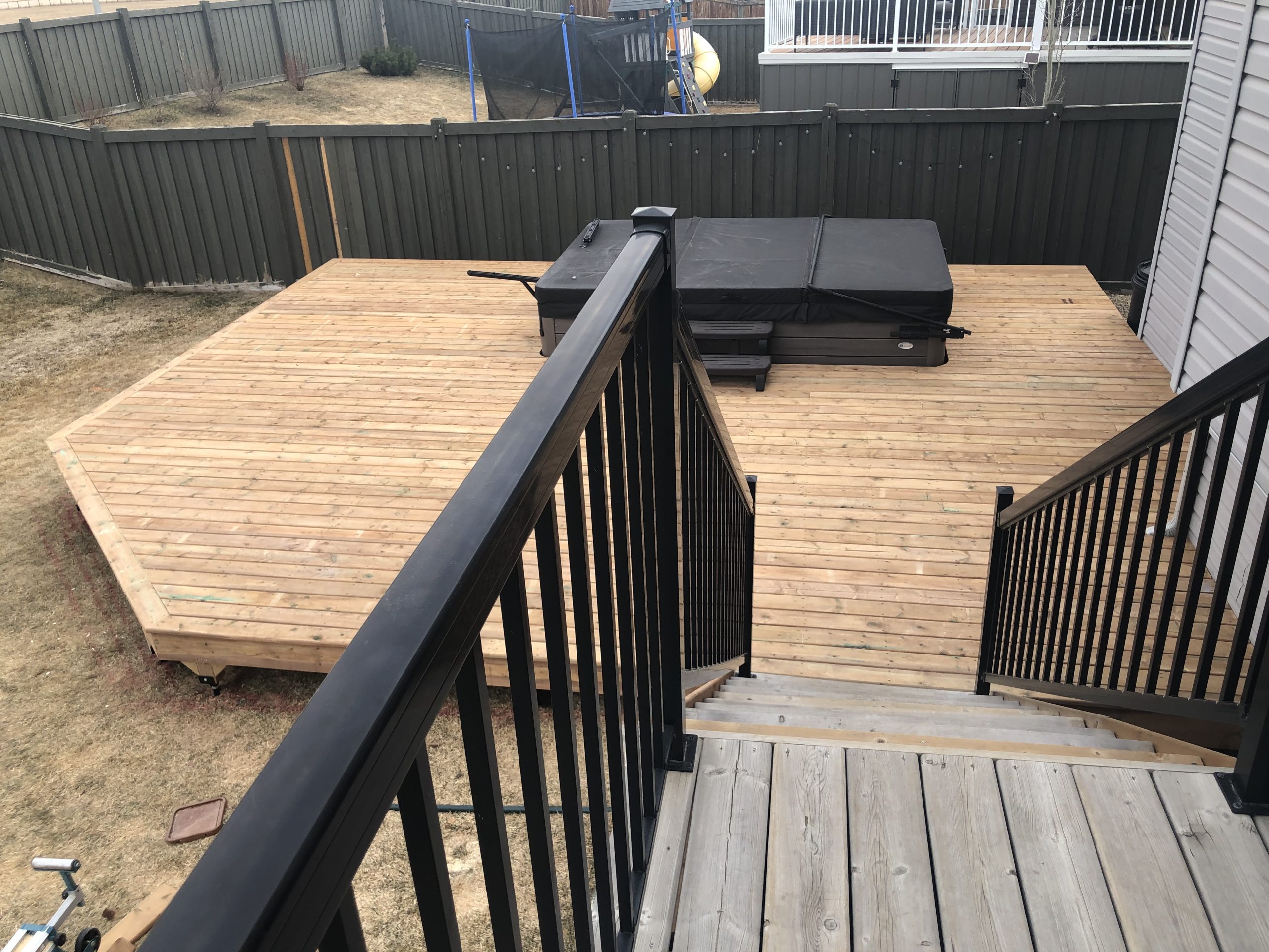 Early stages of deck building with hot tub in Grande Prairie